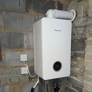 A white tank mounted to a brick wall.