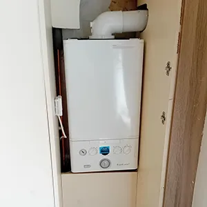 a water heater in the corner of a room