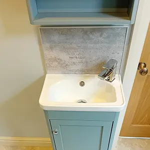A bathroom with a sink and a cabinet.