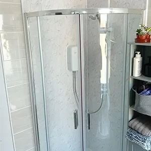 A walk in shower sitting next to a bathroom sink.