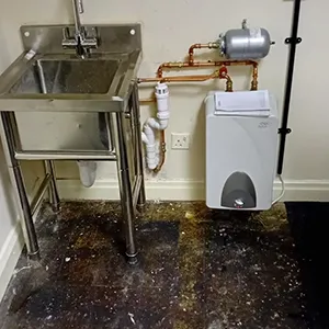 a bathroom with a sink, toilet and a water heater