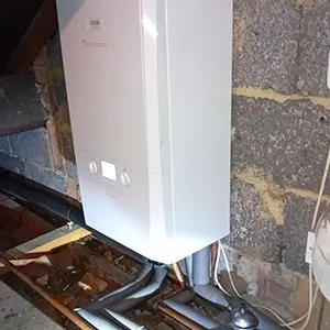 A white computer sitting on top of a wooden table.