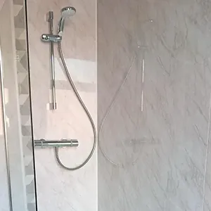 A walk in shower sitting next to a toilet.